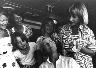 Photograph depicting a woman applying makeup to another woman