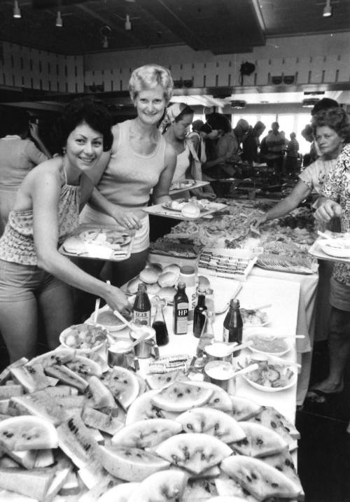 Photograph depicting a group of women at a buffet