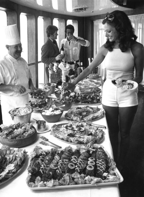 Photograph depicting a woman at a buffet