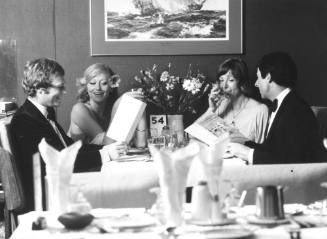 Two couples dining in a ship's restaurant