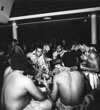 Photograph depicting a group of Pacific Islands musicians performing