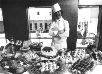 Photograph depicting a chef with an array of food