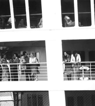 Photograph depicting a group of people on a balcony