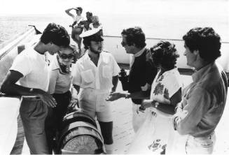 Photograph depicting a group of people looking at ORIANA's telegraph