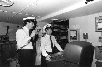 Photograph depicting the captain and officer on ORIANA's bridge