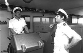 Photograph depicting two officers on ORIANA's bridge