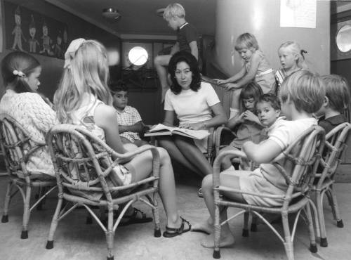 Photograph depicting a group of children at a reading activity