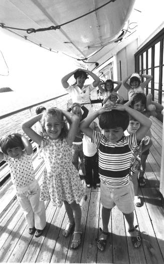 Photograph depicting a group of children playing on deck