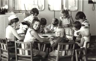 Photograph depicting a group of children playing board games