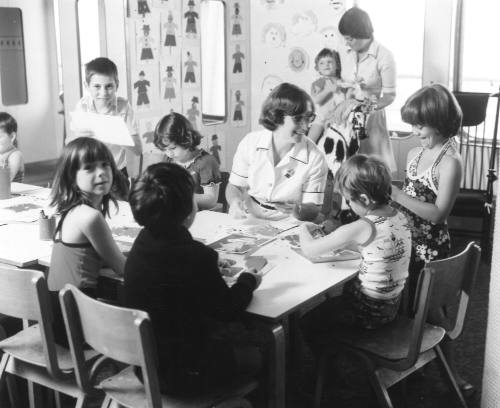 Photograph depicting a group of children playing board games