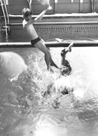 Photograph depicting two children playing greasy pole