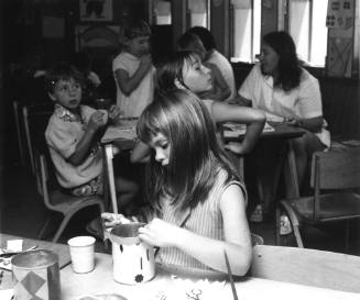 Photograph depicting a girl doing craft