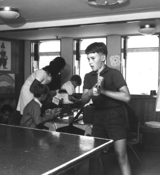 Photograph depicting a boy playing table tennis