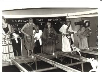 Photograph depicting a group of women playing horse races