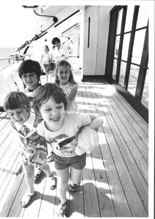 Photograph depicting children playing on deck