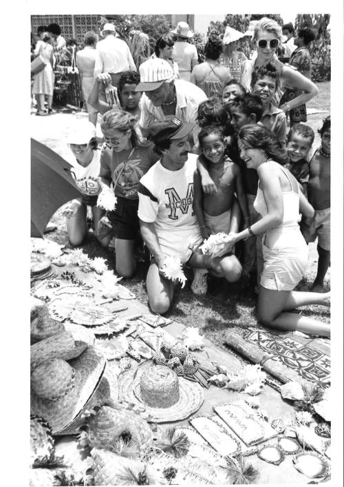 Photograph depicting a group of tourist shopping ashore