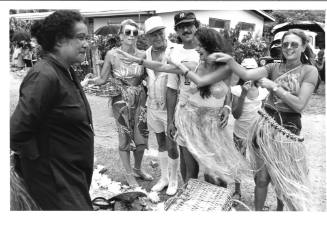 Photograph depicting a group of tourists shopping ashore