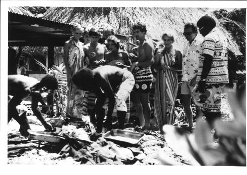 Photograph depicting a group of tourists shopping ashore