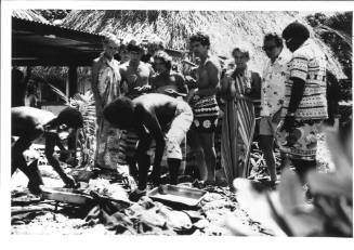 Photograph depicting a group of tourists shopping ashore