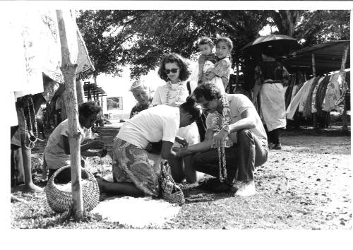 Photograph depicting a group of tourists shopping ashore