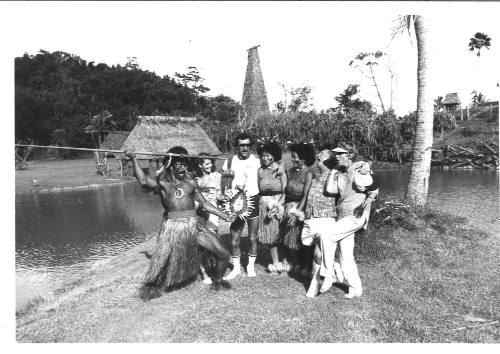 Photograph depicting a group of tourists with a group of Pacific Islanders