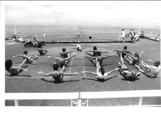 Photograph depicting a group of passengers excercising on deck