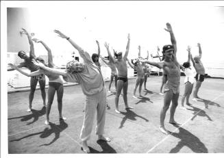 Photograph depicting a group of passengers excercising on deck