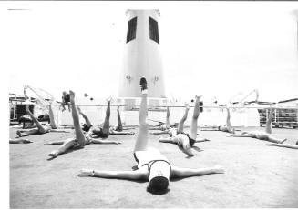 Photograph depicting a group of passengers excercising on deck