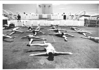 Photograph depicting a group of passengers excercising on deck