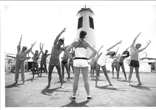 Photograph depicting a group of passengers excercising on deck