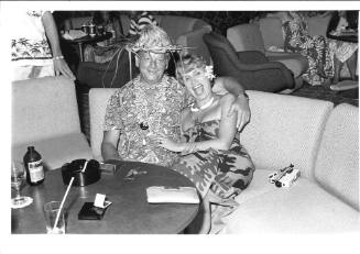 Photograph depicting a couple sitting at a bar's table