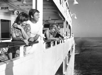 Photograph depicting passengers on the ship's balcony