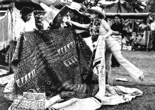 Photograph depicting a group of tourists shopping ashore