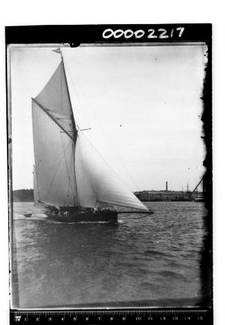 Yacht, possibly ERA or VOLUNTEER, off Garden Island, Sydney Harbour