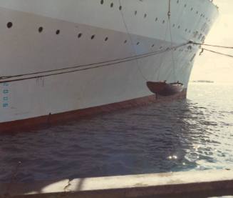 Photograph depicting CHILD OF BOUNTY raft boat being hauled from ORIANA's deck