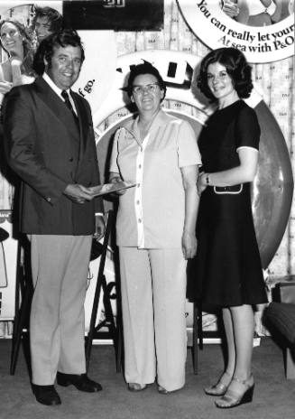 Photograph depicting a three people posing for the camera