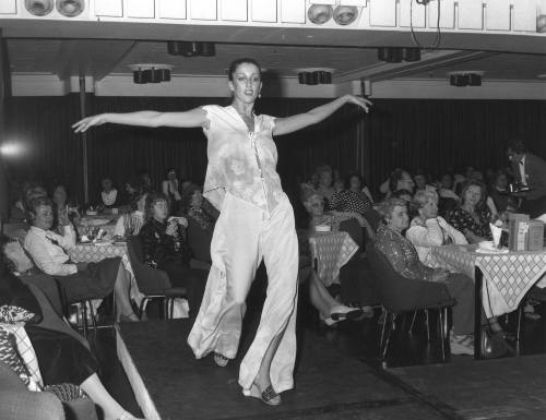 Photograph depicting a woman walking on a catwalk