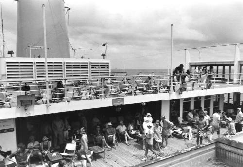 Photograph depicting passengers relaxing on deck