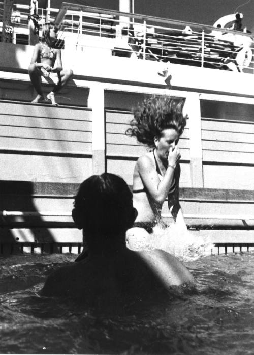 Photograph depicting a woman jumping into a ship's pool