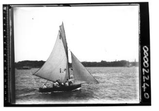 A gaff sloop sailing off Farm Cove, Sydney Harbour, with several of the crew visible
