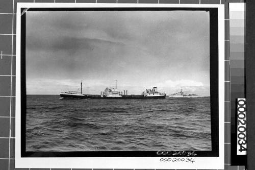 Image of the motor tanker, MV ERODONA, at sea with a naval vessel in the background