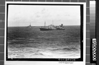 Image of the motor tanker, MV ERODONA, at sea with a naval vessel in the background