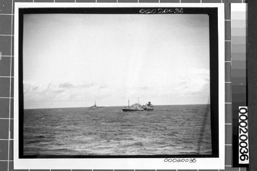 Image of the motor tanker, MV ERODONA, at sea with a naval vessel in the background