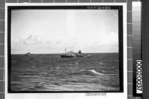 Image of the motor tanker, MV ERODONA, at sea with a naval vessel in the background