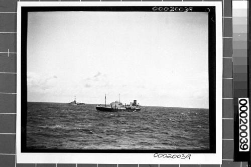 Image of the motor tanker, MV ERODONA, at sea with a naval vessel in the background