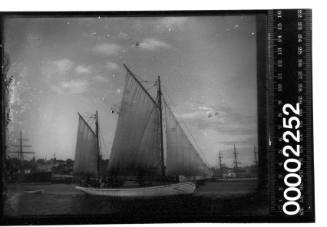 Gaff ketch sailing on an unidentified harbour