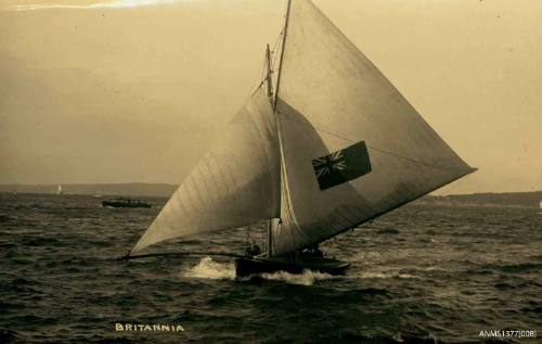 Postcard featuring a photograph of the skiff BRITANNIA sailing on the water