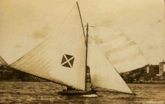 Postcard featuring a photograph of a skiff sailing in the water, with a flag on the sail with a white cross