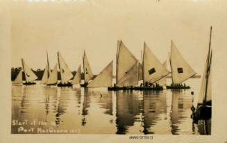 Postcard featuring a photograph of several skiffs lines up in the water, each with a different flag or symbol on its sails