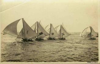 Postcard featuring a photograph of five skiffs, four side by side in a line